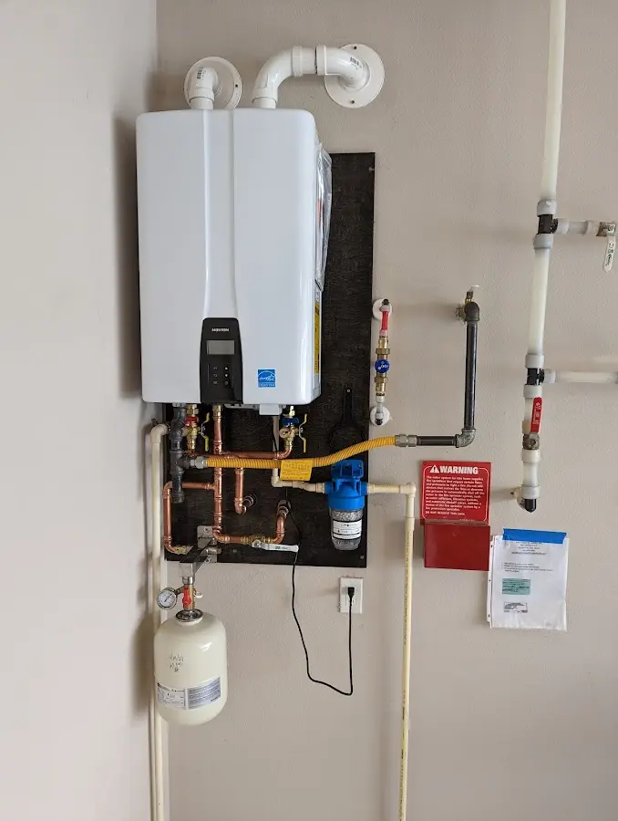 Professional plumber installing copper piping in a Alexandria home